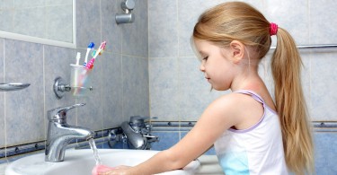 15960327 - little girl washing in bathroom
